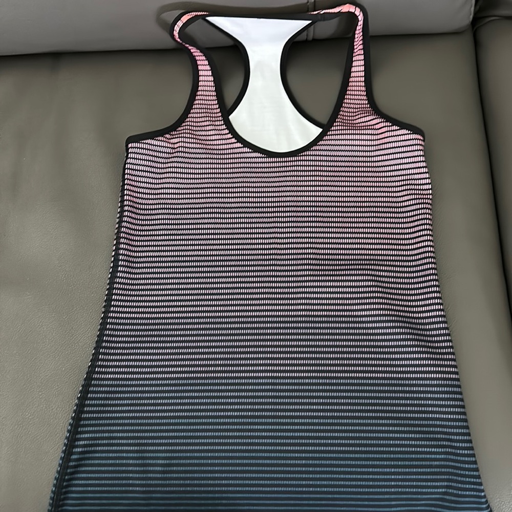 Lululemon tank Size 4 Thicker hold you in kind of fabric. Pink to grayish color